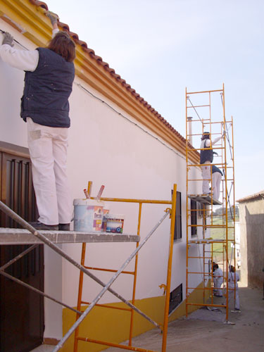 Alumnos/as del taller de pintura pintando el edificio del Ayuntamiento del Risco, haga clic para ampliar la imagen