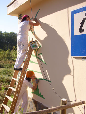 Imagen de las alumnas del taller de pintura pintando la fachada del centro de interpretacin, haga clic en la imagen para ampliar la foto